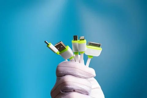 A bunch of plugs for different types of charging connectors in white. Diverse Foto stock