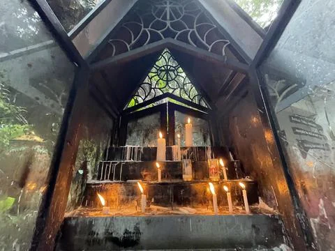 Bunch of prayers candle flames glowing in the dark create a spiritual atmosphere Stock Photos