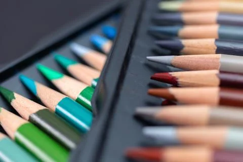 Bunch of random colored pencils, close up macro. Black background Stock Photos