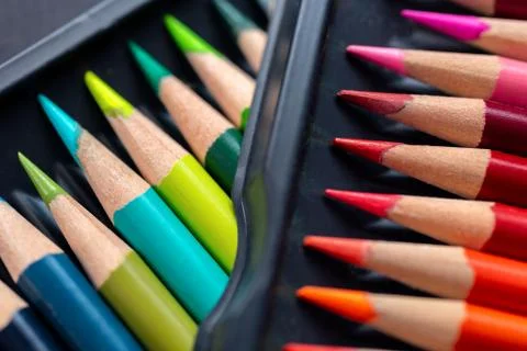 Bunch of random colored pencils, close up macro. Black background Stock Photos
