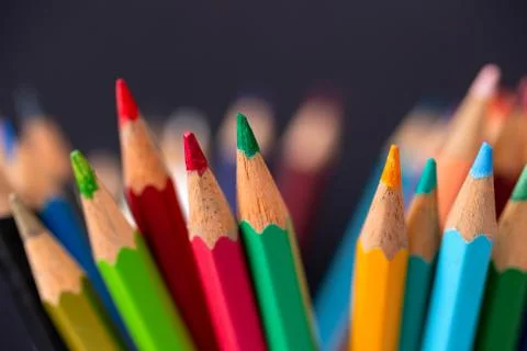 Bunch of random colored pencils, close up macro. Black background Stock Photos