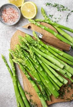 Bunch of raw asparagus stems with different spices Foto stock