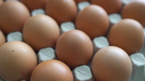 Bunch of raw chicken eggs in carton box Stock Footage 127431795