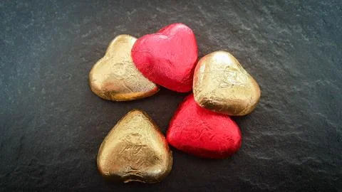 Bunch of red and golden hearts on black background Stock Photos