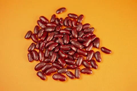 Bunch of red beans on an orange background Stock Photos