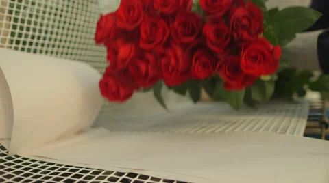 Bunch of red roses being wrapped in net Stock Footage 50177396