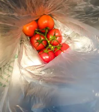 A bunch of red tomatoes packed in plastic. Stock Photos