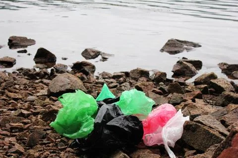A bunch of reusable, multi-colored plastic bags polluting the environment. Ga Stock Photos