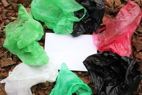 A bunch of reusable, multi-colored plastic bags polluting the environment. Stock Photos