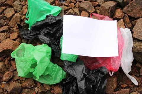 A bunch of reusable, multi-colored plastic bags polluting the environment. Stock Photos