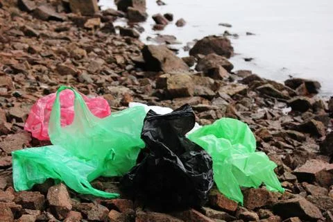 A bunch of reusable, multi-colored plastic bags polluting the environment. Ga Stock Photos