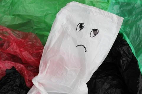 A bunch of reusable, multi-colored plastic bags polluting the environment. Stock Photos