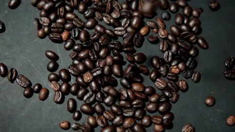 Bunch of roasted coffee beans being poured onto black surface Stock Footage 162517680