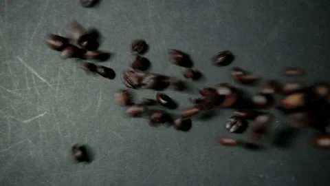 Bunch of roasted coffee beans being poured onto black surface Stock Footage 162631435