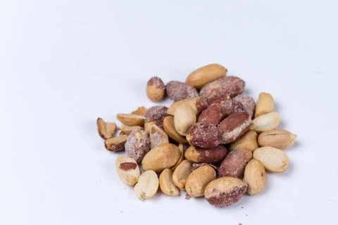Bunch of roasted peanuts on the white background Stock Photos