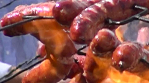 A bunch of sausages on fire in slow motion Stock Footage 67628700