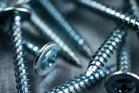A bunch of self-tapping screws on the table. Stock Photos