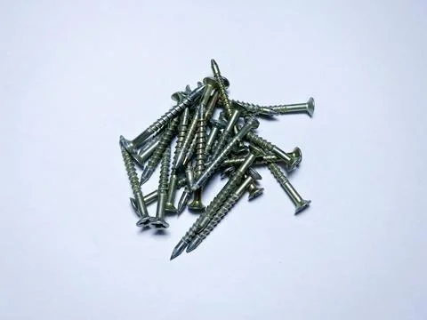A bunch of self-tapping screws on a white insulated background Stock Photos