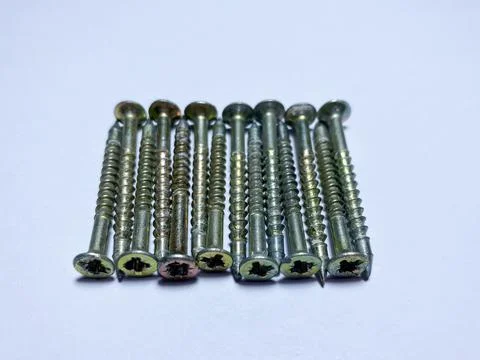 A bunch of self-tapping screws on a white insulated background Stock Photos