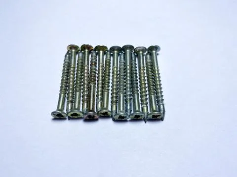 A bunch of self-tapping screws on a white insulated background Stock Photos
