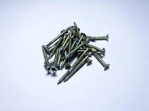 A bunch of self-tapping screws on a white insulated background Stock Photos