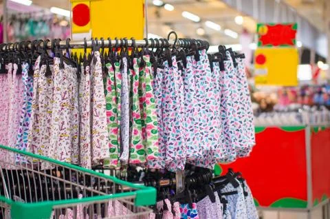 Bunch of shorts with different patterns on hanger in supermarket Stock Photos