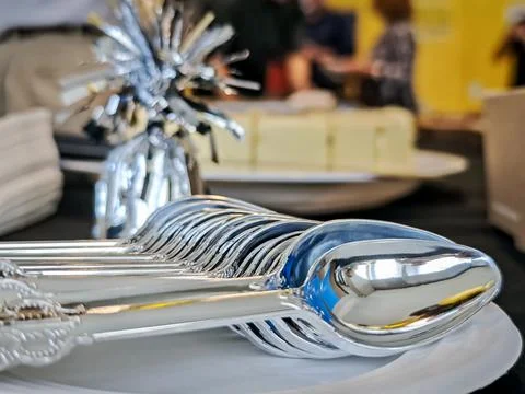 Bunch of silver dessert spoons on a serving plate Stock Photos