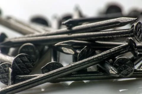 A bunch of small construction nails. macro photography. Slow motion close-up Stock Photos