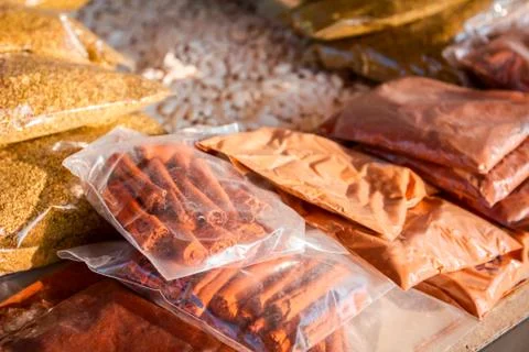Bunch of spices packed in plastic bag at outdoor market place Stock Photos