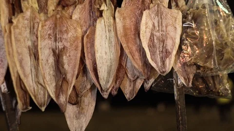 A bunch of squid dries against the night sky. Stock Footage 100876470