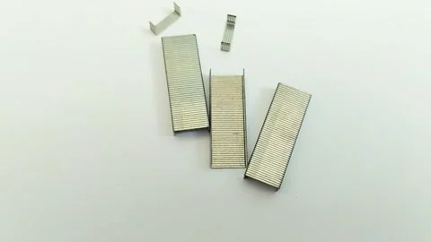 A bunch of staples on a white background Stock Footage 311150379