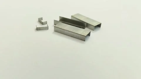 A bunch of staples on a white background Видео 311150665
