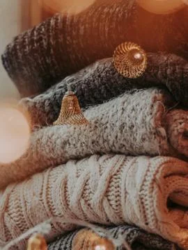 A bunch of sweaters, light bulbs, lanterns, cozy winter interior details, hom Stock Photos