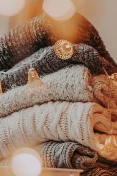 A bunch of sweaters, light bulbs, lanterns, cozy winter interior details, hom Stock Photos