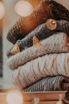 A bunch of sweaters, light bulbs, lanterns, cozy winter interior details, hom Stock Photos