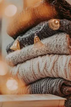 A bunch of sweaters, light bulbs, lanterns, cozy winter interior details, hom Stock Photos