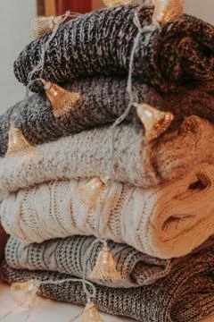 A bunch of sweaters, light bulbs, lanterns, cozy winter interior details, hom Stock Photos