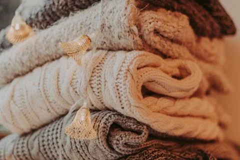 A bunch of sweaters, light bulbs, lanterns, cozy winter interior details, hom Stock Photos