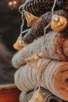 A bunch of sweaters, light bulbs, lanterns, cozy winter interior details, hom Stock Photos
