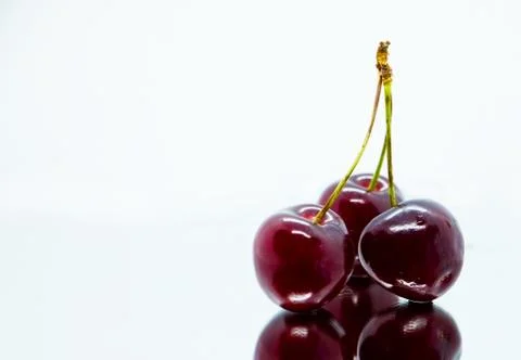 Bunch of sweet cherries in the mirror reflection Stock Photos