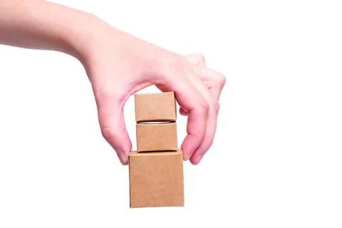 Bunch of tiny shipping boxes pinch held isolated Stock-Fotos