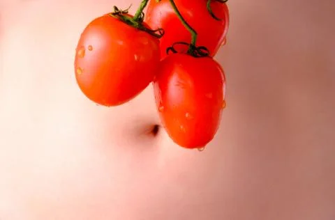 Bunch of tomatoes on the background of stomach Stock Photos