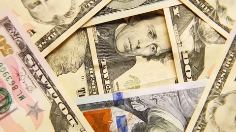 A bunch of US dollar banknotes of money are spinning in close-up. Stock Footage 196721477