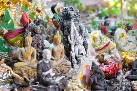 Bunch of various old buddhist statues background Stock Photos