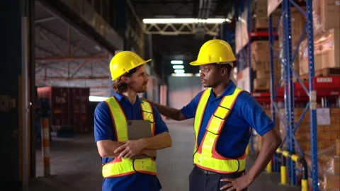 A bunch of warehouse workers are reviewing the list of items based Video stock 308952808