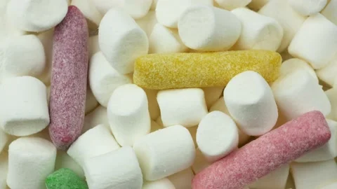 Bunch of white marshmallows with a few colored candies Stock Footage 169817003