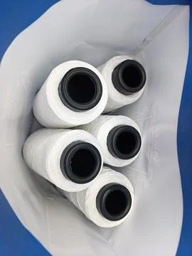 A bunch of white spools of thread in a white bag Stock Photos