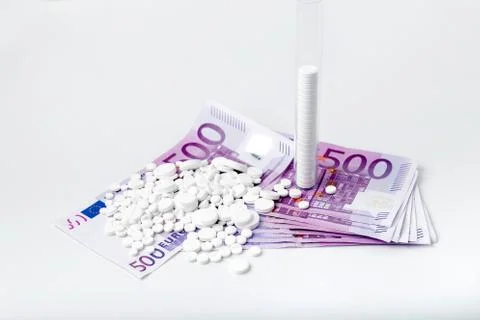 Bunch of white tablets with banknotes Stock Photos