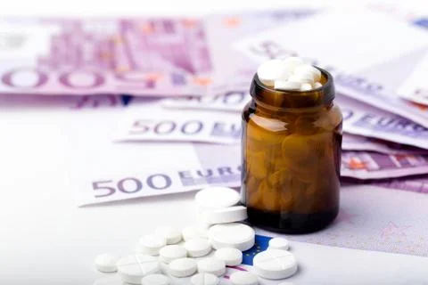 Bunch of white tablets with banknotes Stock-Fotos