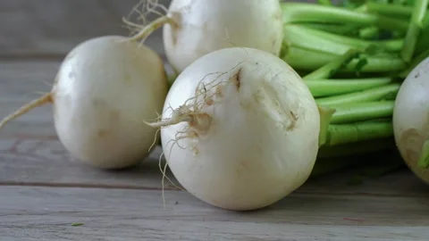 Bunch of white turnips on wooden background, close up view Stock Footage